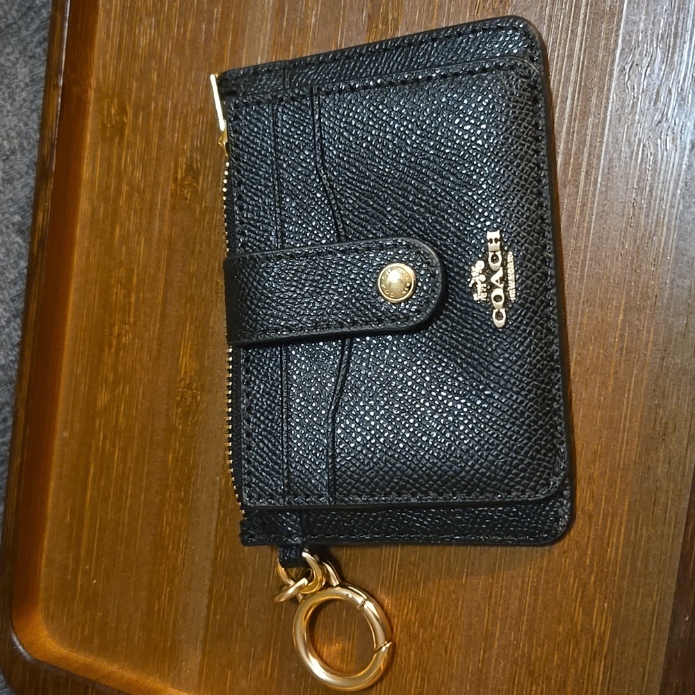 Coach card wallet key chain with gold accents.
